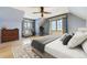 Bright bedroom features hardwood floors, area rug, and large windows at 2285 N Monaco Pkwy, Denver, CO 80207