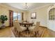 Elegant dining room with chandelier, seating for six, and large window at 2285 N Monaco Pkwy, Denver, CO 80207