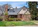 Charming brick home featuring a gabled roof, dormer windows, and well-manicured lawn at 2285 N Monaco Pkwy, Denver, CO 80207
