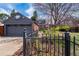 Garage with mature landscaping, fenced yard, and partial view of home's exterior at 2285 N Monaco Pkwy, Denver, CO 80207