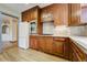 Well-lit kitchen with wood cabinets, stainless steel oven, and ample counter space at 2285 N Monaco Pkwy, Denver, CO 80207