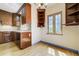 Charming kitchen nook with wood cabinetry, ample storage and natural light at 2285 N Monaco Pkwy, Denver, CO 80207
