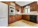 Traditional kitchen featuring wooden cabinetry, stainless steel appliances, and a functional layout at 2285 N Monaco Pkwy, Denver, CO 80207
