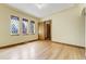 Bright living room featuring hardwood floors, wood trim, and large windows letting in natural light at 2285 N Monaco Pkwy, Denver, CO 80207