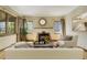 Bright living room with a decorative fireplace, hardwood flooring, and a comfortable seating arrangement at 2285 N Monaco Pkwy, Denver, CO 80207