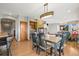 Bright dining room with a wood table, modern lighting, and fireplace viewed from the seating area at 457 Buena Vista Rd, Golden, CO 80401