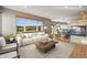 Spacious living room featuring a cozy fireplace, large windows with scenic views, and an open-concept layout at 457 Buena Vista Rd, Golden, CO 80401