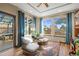 Charming sun room with large windows, comfortable seating, and access to an outdoor patio at 457 Buena Vista Rd, Golden, CO 80401