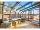 Relaxing sunroom with glass ceilings and walls, wicker furniture, and a mini trampoline at 457 Buena Vista Rd, Golden, CO 80401