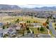 Scenic aerial of the community's park, playground, and open spaces with mountain views at 6088 Rogers Cir, Arvada, CO 80403