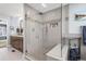 Luxurious bathroom with a glass-enclosed shower, built-in bench, and decorative tile accents at 6088 Rogers Cir, Arvada, CO 80403