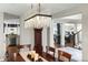 Dining room with hardwood floors and chandelier leading into the living room and kitchen at 6088 Rogers Cir, Arvada, CO 80403