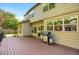 Backyard view from the deck features a grill, lawn, and beautiful home exterior at 7420 S Houstoun Waring Cir, Littleton, CO 80120