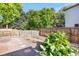 The backyard has a garden area with lush rhubarb surrounded by a wooden fence for privacy at 7420 S Houstoun Waring Cir, Littleton, CO 80120