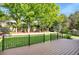 Spacious backyard with a well-manicured lawn, trees, and a black fence, as seen from the deck at 7420 S Houstoun Waring Cir, Littleton, CO 80120