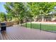 Spacious backyard with a well-manicured lawn, trees, and a black fence, as seen from the deck at 7420 S Houstoun Waring Cir, Littleton, CO 80120