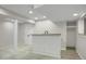 Finished basement with bar, neutral carpet, and modern lighting at 7420 S Houstoun Waring Cir, Littleton, CO 80120