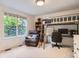 Bright bedroom with bunk bed, desk, and large window view at 7420 S Houstoun Waring Cir, Littleton, CO 80120
