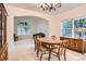Dining room with carpet, a large window and a dining table with six chairs at 7420 S Houstoun Waring Cir, Littleton, CO 80120