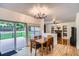 Inviting dining room with a wooden table, slider doors to the patio, and natural light at 7420 S Houstoun Waring Cir, Littleton, CO 80120