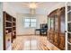 Bright office space with hardwood floors, a large window, and built-in shelving at 7420 S Houstoun Waring Cir, Littleton, CO 80120