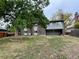 View of the home's backyard, a spacious green area with mature shade tree at 4115 S Vincennes Ct, Denver, CO 80237