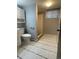 Well-lit bathroom featuring a ceramic tiled floor and shower at 4115 S Vincennes Ct, Denver, CO 80237