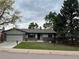Charming single-story home with an attached garage and a well-maintained front lawn at 4115 S Vincennes Ct, Denver, CO 80237