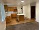 Open kitchen featuring wood cabinetry, an island cooktop, and updated appliances at 4115 S Vincennes Ct, Denver, CO 80237