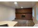 Bright living room with a brick fireplace and white wood paneled wall at 4115 S Vincennes Ct, Denver, CO 80237