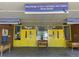 Exterior shot of Samuels Elementary school featuring yellow doors, planters and signage at 4115 S Vincennes Ct, Denver, CO 80237