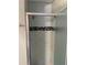 Shower featuring gray subway tiles and a decorative mosaic tile accent at 4115 S Vincennes Ct, Denver, CO 80237