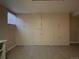 Finished basement storage area with built-in cabinetry and tile flooring at 4115 S Vincennes Ct, Denver, CO 80237