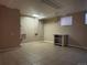 Basement utility room with tiled floor, sink, and storage at 4115 S Vincennes Ct, Denver, CO 80237