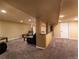 Large finished basement boasts neutral carpet, recessed lighting, and bar area at 940 S Geneva St, Aurora, CO 80247