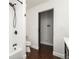 Clean bathroom with a large soaking tub and dark wood details offers a minimalist and relaxing space at 940 S Geneva St, Aurora, CO 80247