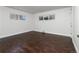 Bright bedroom features two large windows and hardwood floors, offering a simple, stylish, and comfortable retreat at 940 S Geneva St, Aurora, CO 80247