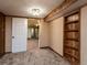 Cozy bedroom with wood-paneled walls and built-in bookshelf; doorway view at 940 S Geneva St, Aurora, CO 80247