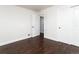 Bright bedroom features dark wood floors, white walls, and closet and entry doors at 940 S Geneva St, Aurora, CO 80247