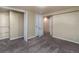 Bedroom with neutral walls, carpeted floor, closet and access to other rooms at 940 S Geneva St, Aurora, CO 80247