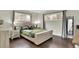 Serene bedroom featuring hardwood floors, neutral walls, and two windows for natural light at 940 S Geneva St, Aurora, CO 80247