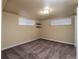 Basement bedroom with neutral walls, carpeted floor and two windows at 940 S Geneva St, Aurora, CO 80247