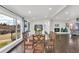 Bright dining room with a large window, wood table, and fireplace with a brick surround at 940 S Geneva St, Aurora, CO 80247