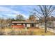 Quaint single-story home featuring a brick facade and well-maintained front lawn at 940 S Geneva St, Aurora, CO 80247