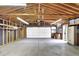 Spacious garage with unfinished walls and ceiling, offering ample storage space at 940 S Geneva St, Aurora, CO 80247