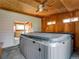Hot tub room with wood ceiling and paneling, and views into the kitchen through the sliding glass door at 940 S Geneva St, Aurora, CO 80247