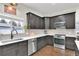 Stylish kitchen with stainless steel appliances, dark wood cabinets, and white subway tile backsplash at 940 S Geneva St, Aurora, CO 80247