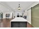 Large kitchen island with pendant lighting and view of the open floor plan at 940 S Geneva St, Aurora, CO 80247