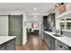 Modern kitchen featuring stainless steel appliances, dark wood cabinets, and hardwood floors at 940 S Geneva St, Aurora, CO 80247