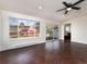 Bright room with ceiling fan, large window and glass slider overlooking a deck at 940 S Geneva St, Aurora, CO 80247
